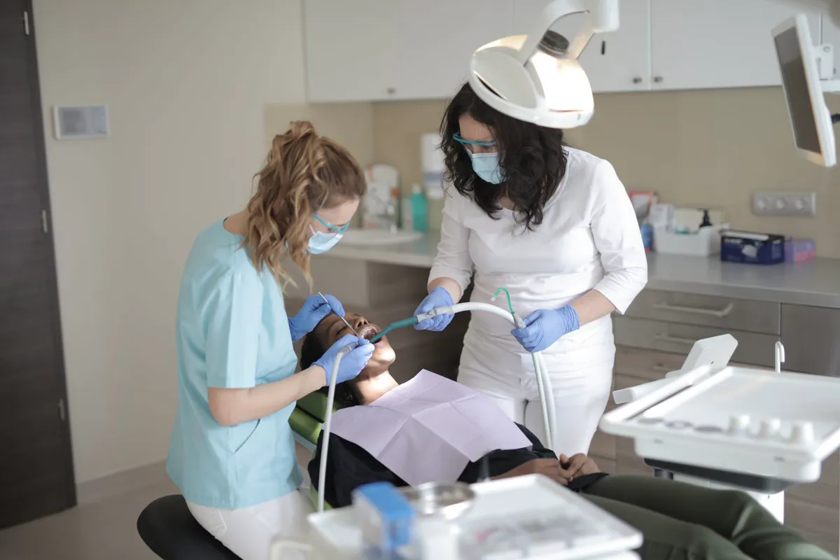 Dental clinicians treating a patient in a dental surgery