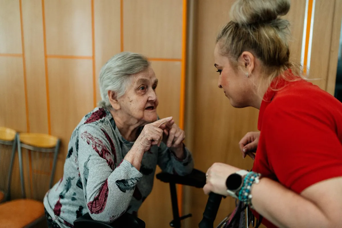 A support worker in conversation with an older client