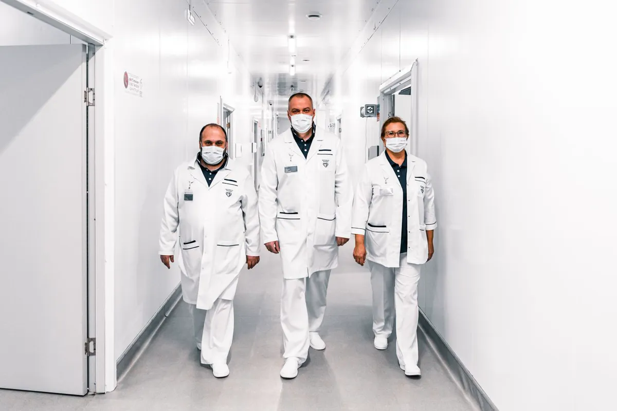 Healthcare professionals walking through a hospital corridor